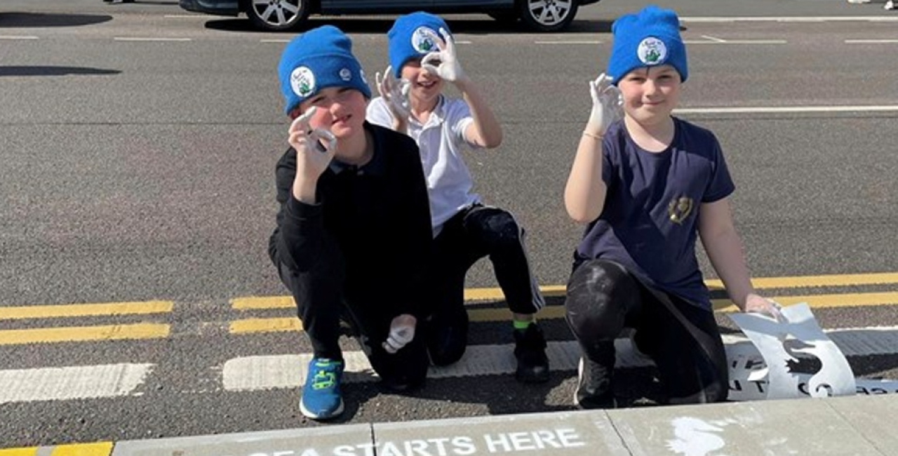 Ullapool Sea Savers ‘refresh’ spray-paint Drain Campaign slogans in village